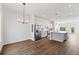 Open-concept kitchen and dining area with stainless steel appliances and wood flooring at 336 Center Lake Ln # A-2, Oviedo, FL 32765