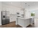 Spacious kitchen with white cabinets, stainless steel appliances, and a center island provides ample workspace at 336 Center Lake Ln # A-2, Oviedo, FL 32765