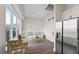 A bright living area with a large window, white couch, dining table, barn door and stainless steel refrigerator at 336 Center Lake Ln # A-2, Oviedo, FL 32765
