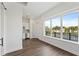 Spacious open floor plan with wood flooring, a large window, and a modern kitchen in the background at 336 Center Lake Ln # A-2, Oviedo, FL 32765