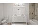 Bathroom features a double vanity, large mirror, and shower-tub combo at 33830 S Haines Creek Rd, Leesburg, FL 34788