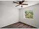 Bedroom with window overlooking trees, ceiling fan and wood flooring at 33830 S Haines Creek Rd, Leesburg, FL 34788