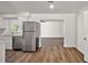 Modern kitchen featuring stainless steel appliances, quartz countertops, and laminate floors at 33830 S Haines Creek Rd, Leesburg, FL 34788