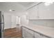 Bright kitchen featuring quartz countertops, white cabinetry, and stainless refrigerator at 33830 S Haines Creek Rd, Leesburg, FL 34788