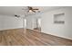 Open living area with laminate flooring, neutral paint, and ceiling fans at 33830 S Haines Creek Rd, Leesburg, FL 34788