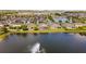 Houses in a lakeside community with lush green surroundings seen from the air at 3936 Parkhouse Dr, Orlando, FL 32824
