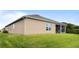A well maintained backyard with lush green lawn and an exterior view of the screened lanai at 3936 Parkhouse Dr, Orlando, FL 32824