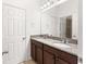 Bathroom featuring double sinks, granite counters, wood cabinets, and a shower at 3936 Parkhouse Dr, Orlando, FL 32824
