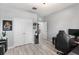 A bedroom with light hardwood flooring, a closet and a modern desk setup at 3936 Parkhouse Dr, Orlando, FL 32824