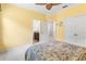 A sunny bedroom with neutral carpet and a view into the bathroom with brown cabinets at 3936 Parkhouse Dr, Orlando, FL 32824