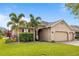 Inviting exterior of the home showcasing a well-kept lawn and a brick driveway at 3936 Parkhouse Dr, Orlando, FL 32824