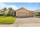 Charming single-story home featuring a brick driveway and lush green lawn with landscaping at 3936 Parkhouse Dr, Orlando, FL 32824