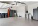 An organized garage with epoxy flooring, storage cabinets, tools and water softener at 3936 Parkhouse Dr, Orlando, FL 32824
