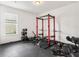 A home gym featuring a weight rack, weights and rubber flooring for comfortable exercising at 3936 Parkhouse Dr, Orlando, FL 32824
