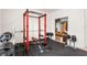 A home gym featuring a weight rack, weights, a bench, and a closet in a well-lit room at 3936 Parkhouse Dr, Orlando, FL 32824