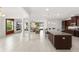 Open-concept kitchen with dark wood cabinets, granite countertops, and seamless flow to the living area at 3936 Parkhouse Dr, Orlando, FL 32824
