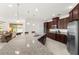 Bright kitchen featuring a large granite island, stainless steel appliances and water views at 3936 Parkhouse Dr, Orlando, FL 32824