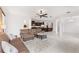 Open-concept living room with tile flooring, a plush sofa, and a seamless transition to the kitchen at 3936 Parkhouse Dr, Orlando, FL 32824