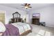 Relaxing main bedroom featuring a ceiling fan, a TV, and an elegant, dark wood bedroom set at 3936 Parkhouse Dr, Orlando, FL 32824