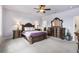 Spacious main bedroom featuring a ceiling fan and an elegant, dark wood bedroom set at 3936 Parkhouse Dr, Orlando, FL 32824