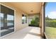 A screened patio with view of the yard and a glimpse of the lake at 3936 Parkhouse Dr, Orlando, FL 32824
