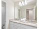 Bright bathroom featuring double sinks with granite countertop and a large mirror at 3966 Lana Ave, Davenport, FL 33897