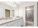 Well-lit bathroom featuring granite countertops, dual sinks, and a glass-enclosed shower for a luxurious feel at 3966 Lana Ave, Davenport, FL 33897