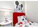 Decorated ' room featuring a Mickey Mouse theme, red accents, and comfortable beds for a playful ambiance at 3966 Lana Ave, Davenport, FL 33897