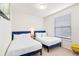 Bright bedroom featuring two twin beds, a TV, and a sunny window with blinds at 3966 Lana Ave, Davenport, FL 33897
