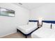 Bright bedroom featuring two twin beds, a TV, and a sunny window with blinds at 3966 Lana Ave, Davenport, FL 33897