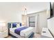 Bright bedroom with blue accent wall, modern nightstands, and comfortable king-size bed with plush bedding at 3966 Lana Ave, Davenport, FL 33897