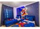 Themed bedroom featuring two twin beds and a character mural on the wall at 3966 Lana Ave, Davenport, FL 33897