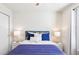 Bright bedroom with blue accent wall, modern nightstands, and comfortable king-size bed with plush bedding at 3966 Lana Ave, Davenport, FL 33897