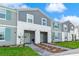 Charming townhome with modern gray siding, white trim, and inviting, well-maintained landscaping at 3966 Lana Ave, Davenport, FL 33897