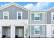 Well-maintained townhome exterior with attractive gray siding, white trim, and a cozy entrance at 3966 Lana Ave, Davenport, FL 33897