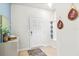 Inviting foyer with decorative accents, built-in shelving, and neutral flooring at 3966 Lana Ave, Davenport, FL 33897