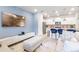 Open-concept living room and kitchen featuring modern finishes, a breakfast bar, and stainless appliances at 3966 Lana Ave, Davenport, FL 33897