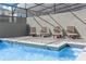 Inviting outdoor pool area with lounge chairs and a secure screened enclosure at 3966 Lana Ave, Davenport, FL 33897