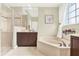 Bright bathroom with a soaking tub, a separate shower, and stylish fixtures at 408 Almeria Ct, Winter Springs, FL 32708