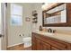 The bathroom features a decorative mirror, earth-toned tile flooring, and a charming design at 408 Almeria Ct, Winter Springs, FL 32708