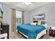The bedroom has a large window, plush carpet, and a calming blue color scheme at 408 Almeria Ct, Winter Springs, FL 32708