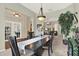 Open dining room with chandelier that flows into the living room at 408 Almeria Ct, Winter Springs, FL 32708