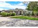 Inviting one-story home with a neatly manicured lawn and symmetrical landscaping, creating curb appeal at 408 Almeria Ct, Winter Springs, FL 32708