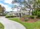 Well-maintained one-story house featuring lush lawn, mature trees, and a curved driveway at 408 Almeria Ct, Winter Springs, FL 32708