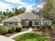 Charming one-story home with manicured landscaping, arched windows, and a welcoming front entrance at 408 Almeria Ct, Winter Springs, FL 32708