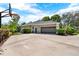 Well-maintained exterior with a large driveway, two-car garage, and basketball hoop at 408 Almeria Ct, Winter Springs, FL 32708