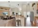 Open-concept kitchen with a breakfast bar seamlessly connected to the living area at 408 Almeria Ct, Winter Springs, FL 32708