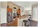 Modern kitchen with stainless steel appliances, granite countertops, and wooden cabinetry at 408 Almeria Ct, Winter Springs, FL 32708