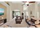 Inviting living room with high ceilings, arched doorways, and comfortable leather furniture at 408 Almeria Ct, Winter Springs, FL 32708