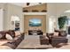 Inviting living room with high ceilings, a fireplace, and open doorways to other rooms at 408 Almeria Ct, Winter Springs, FL 32708